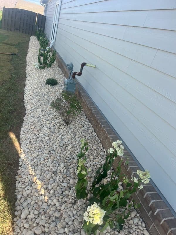 Stunning Garden Makeover with White Stones and Mulch image
